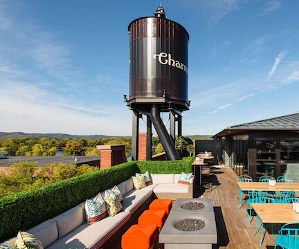 Cozy rooftop patio at Fahrenheit Hotel with beautiful cityscape views.